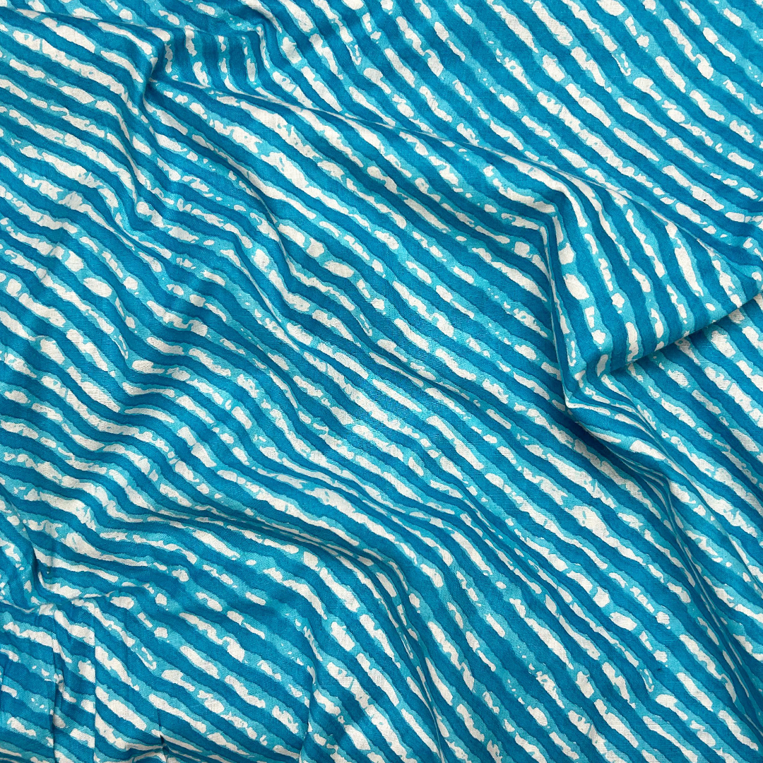 Dynamic blue cotton fabric with cascading white stripe print