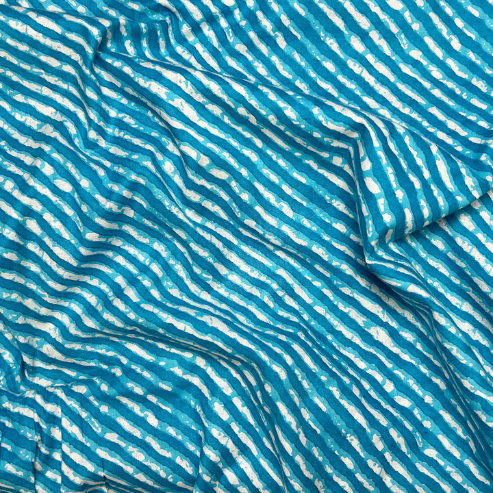 Dynamic blue cotton fabric with cascading white stripe print