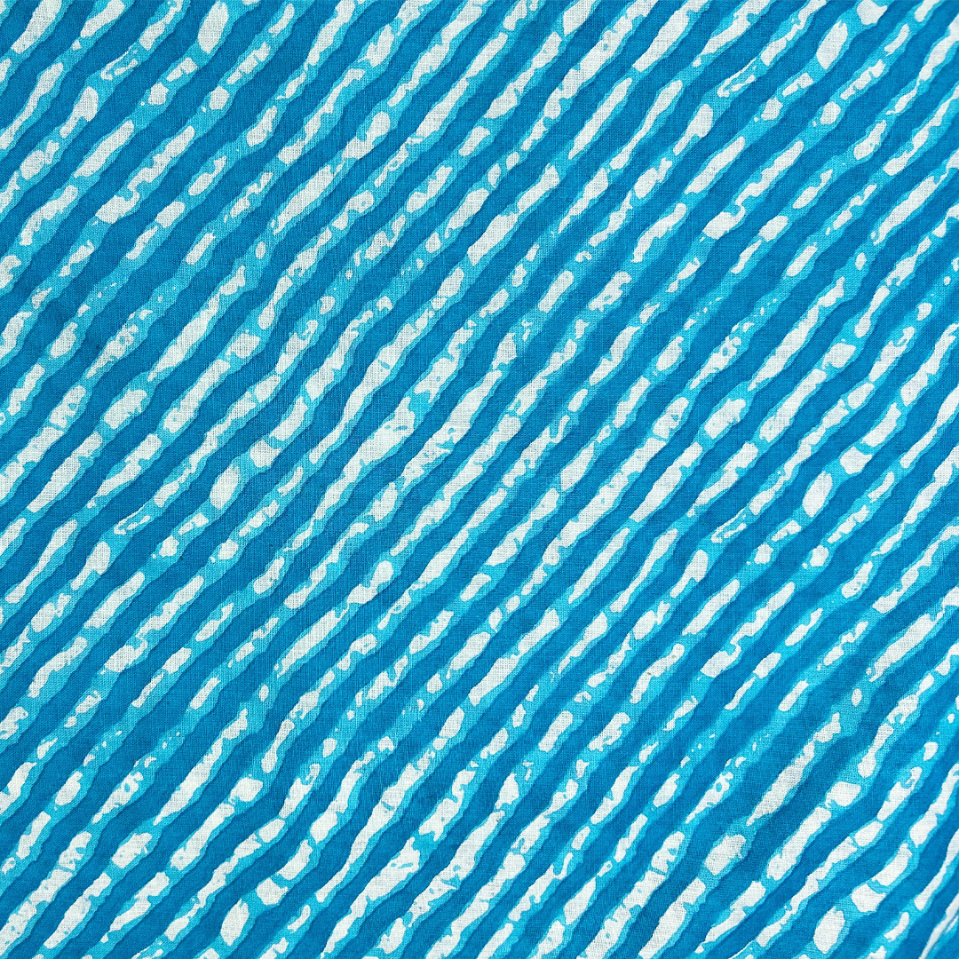 Dynamic blue cotton fabric with cascading white stripe print