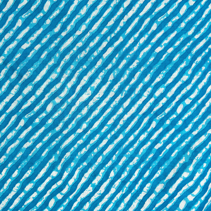 Dynamic blue cotton fabric with cascading white stripe print