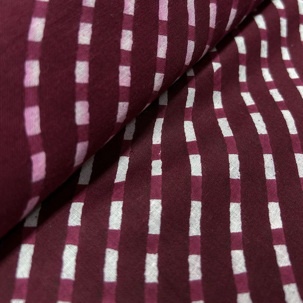 Classic maroon with white stripe pattern on soft cotton fabric, ideal for creating stylish and comfortable clothing.