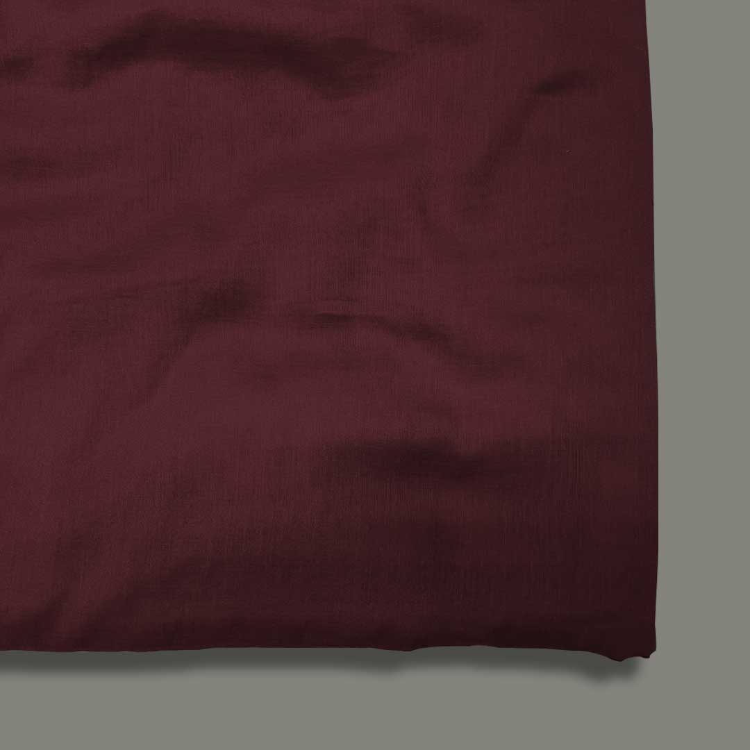 Plush royal maroon mul mul plain cotton fabric, offering unmatched softness and a rich hue for elegant and comfortable garments.