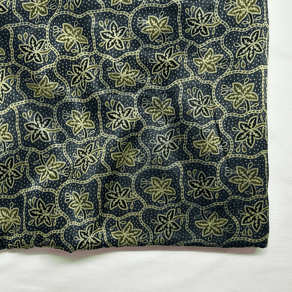 Navy blue silk fabric with green-shaded floral Ajrakh print, embodying traditional artistry at Fabrics @StudioLCX.