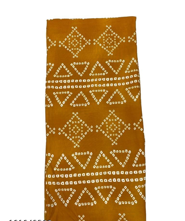 Vibrant mustard yellow with traditional Bandhani print on rayon fabric, ideal for crafting stylish and comfortable apparel.