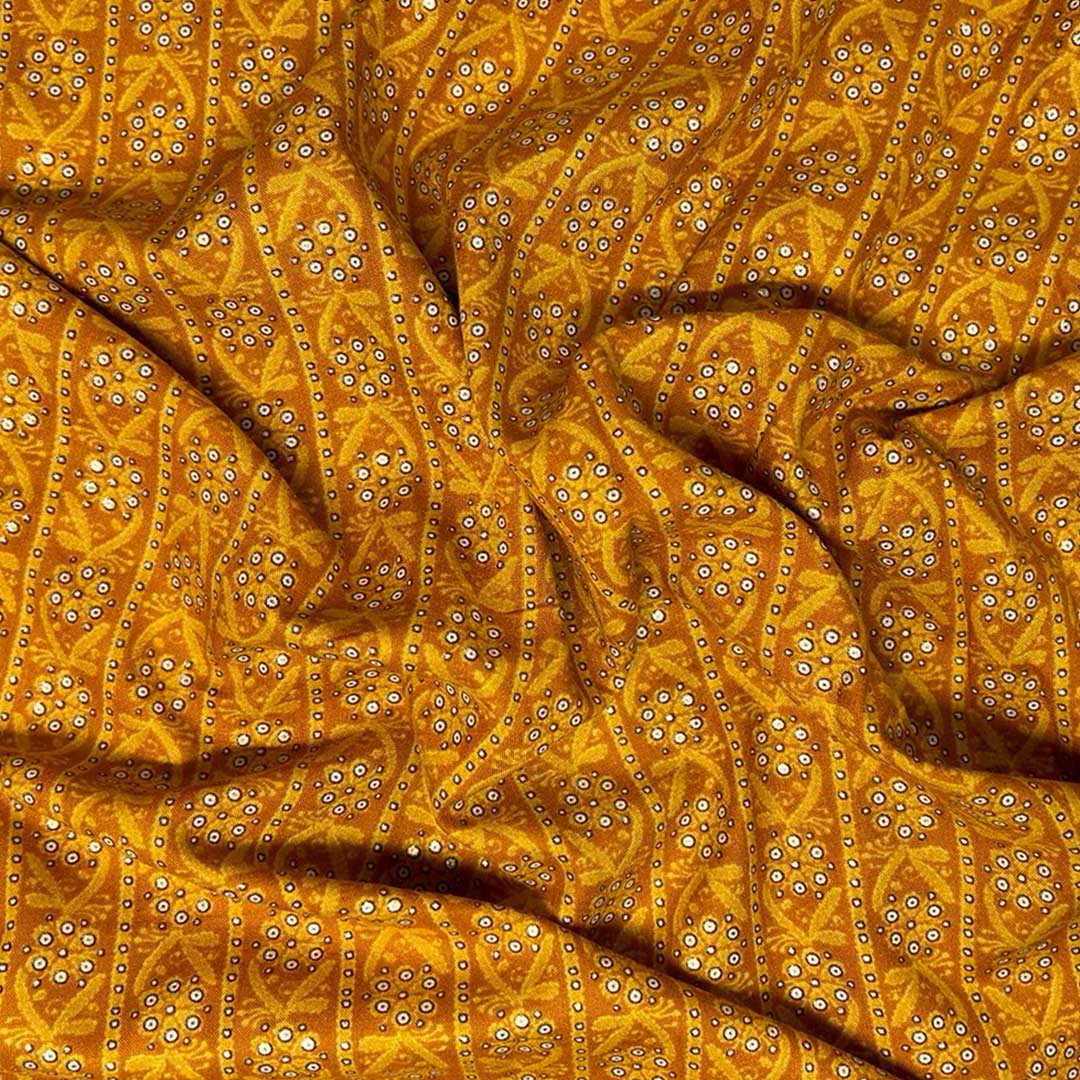 Mustard yellow rayon fabric featuring delicate floral prints, perfect for crafting vibrant and airy fashion pieces.