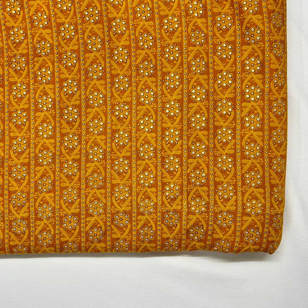 Mustard yellow rayon fabric featuring delicate floral prints, perfect for crafting vibrant and airy fashion pieces.