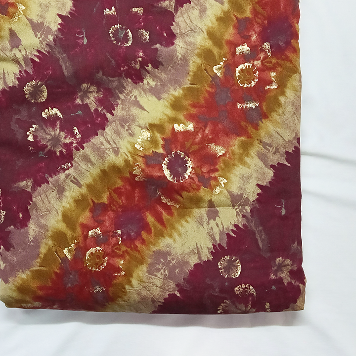 Trendsetting maroon stripes on muslin fabric, combining fashion-forward design with the softness and versatility of muslin for stylish garments.